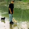 Johnny Oliver helps introduce 6 week old pups to water